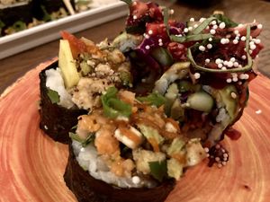 Earthy.  Tofu, avocado, fried jalapeños, carrots and more.   at The Slippery Mermaid Sushi Bar in Navarre