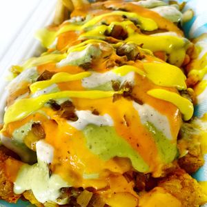 50/50 Dogpile - 2 Patties, Grilled Onions, Cheese, Tots, Fries & All the sauces... Vegan & Glutenfree  at Monty's Good Burger - 3rd St in Los Angeles