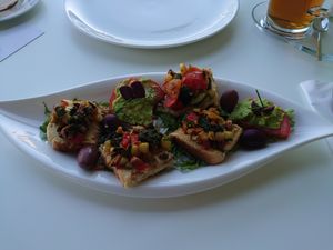 Hummus on toast squares, tomatoes smeared with smashed avocado, mixed salad and olives 😍 at Hotel Seventh in Cavtat