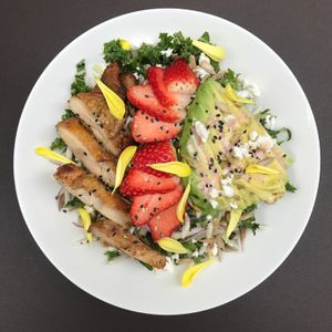 Kale, cucumber, turnip, avocado, strawberry, sunflower seeds with a lemon - za'atar vinaigrette. This picture includes chicken schwarma & feta cheese. (can be made vegan)  at Salam in Tokyo