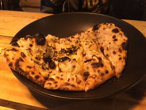 Garlic bread, with oregano and cheese at Plant Base in Lisbon