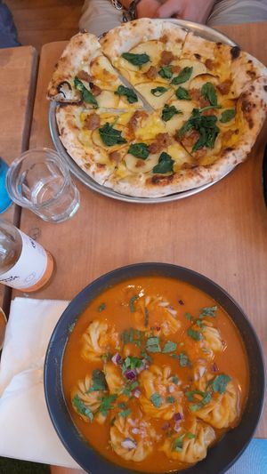 Curry momos and pizza at Plant Base in Lisbon