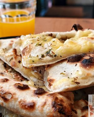 Pizza bread with vegan cheese at Plant Base in Lisbon