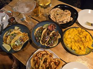 Clockwise L-R: chickpea tacos, spicy seitan tacos, garlic bread,  mac'n'cheez, "ring of fire" spicy onion rings (bottom of picture) at Plant Base in Lisbon