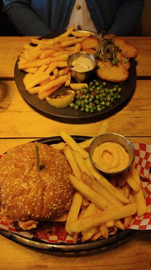 Vegan BBQ "bacon" burger, French fries & vegan "fish & chips". at Plant Base in Lisbon