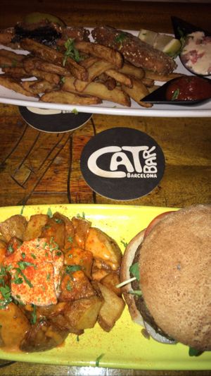 Nuestra comida (hamburguesa de semillas y fish and chips) at Cat Bar in Barcelona
