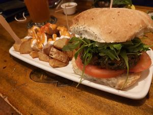Burger was just OK. Nothing more than that. The potatos were amazing!!! The sauce worked really good with it. at Cat Bar in Barcelona
