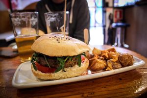 burger with patatas bravas at Cat Bar in Barcelona