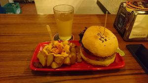 Mexican burger, patatas bravas y sidra at Cat Bar in Barcelona