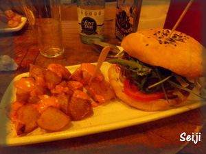Vegan Burger with fried potatoes and spicy sauce at Cat Bar in Barcelona