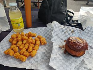 Now that's what I call a birthday lunch - Nashville Hot Chicken sandwich and tater tots. at Nom Burgers in Austin