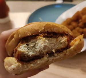 Nashville Hot Chicken sandwich and tater tots - take a bite, I know you want to! at Nom Burgers in Austin
