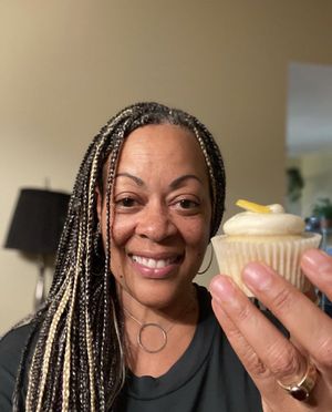 Lynn celebrating her birthday with a lemon cupcake.  at Cupt Cupcakes in Silver Spring