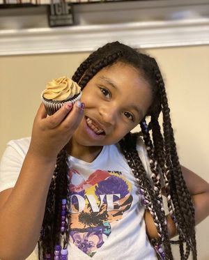 Zoey with a chocolate peanut butter cupcake 🧁  at Cupt Cupcakes in Silver Spring
