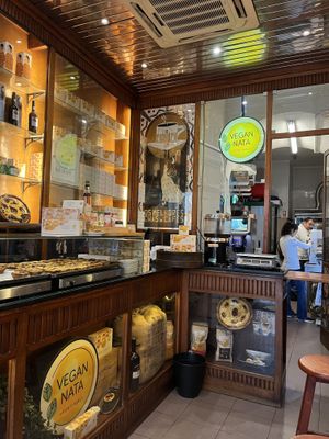 Tarts keeping warm and stools on right    at Vegan Nata - Chiado in Lisbon