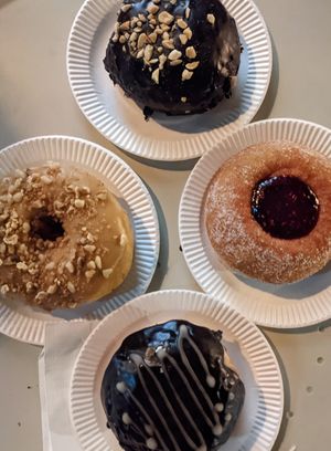 Arachides-chocolat, noix-érable, chocolat -creme pâtissière & confiture de framboise at La Beignerie in Montreal