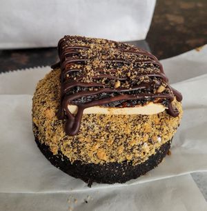 Fireside smores, a seasonal Christmas donut. Chocolate cake donut with chocolate glaze, Graham crackers crumbs, marshmallow, and chocolate drizzle #Veganuary at Beacon Doughnuts in Chicago