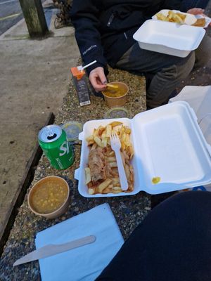 Battered sausage, chips and curry sauce at French's Fish Shop in Wells-next-the-sea