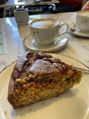 Orange cake and coffee with oat milk at Bloomy Market in Setubal