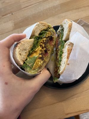 2000 and Juan - a burrito bagel with a bean/quinoa patty, guacamole, tomatoes, crushed corn chips, chipotle mayo (vegan), and lettuce on a rosemary bagel. Filling! Delicious!  at Beam Me Up Bagels - City in Dunedin