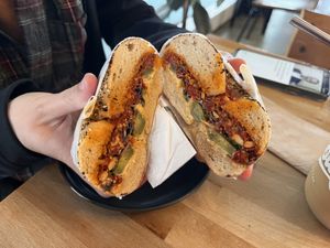 Red dwarf - sundried tomato pesto, hummus, pickles on an everything bagel. Recommended by staff for the top notch hummus. Great flavors!  at Beam Me Up Bagels - City in Dunedin