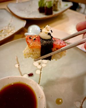 Tomagiri: nigiri with marinated plum tomato with seaweed, Tamari sauce and sesame seeds, topped with cashew nut cream cheese and spicy vegan mayo at Veganashi - Gluten Free Sushi in Barcelona