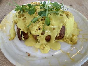 Eggs Benedict with sourdough bread   at Pequeno Café e Bistrô - Arroios in Lisbon