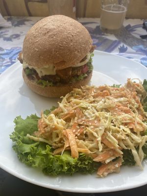 buffalo tempeh 'bacon' cheese burger with a lentil beet patty and a side of coleslaw!  at Salud Para Vida in San Pedro La Laguna