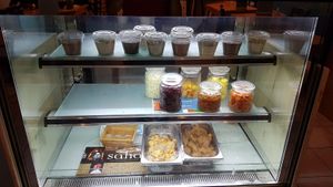 Desserts and ingredients display at C'est Bon Salades Maison in Marseille
