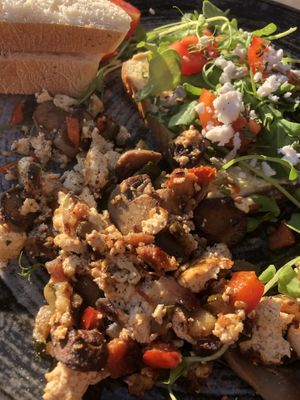 Tofu scramble and hummus toast with vegan feta   at Cafinho in Piran