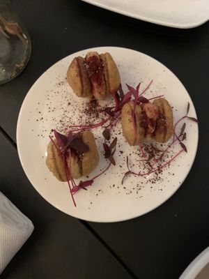 Baked bean macarons with hummus in the middle  at Frank. in Brussels