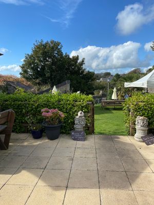 Outside area, there are also some tables under cover & inside seating at Manorbier House in Manorbier