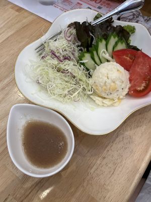 Salad with onion dressing  at KOMEDA is in Tokyo