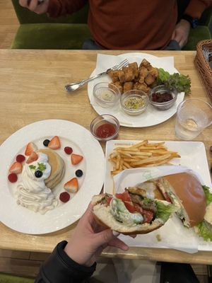 Pancakes with fruit (left), tofu fritters (top right), avocado teriyaki burger (bottom right)  at KOMEDA is in Tokyo