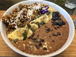 Cocoa, coconut, date smoothie bowl with granola & fruit at Wise Cicada Wholefood Cafe in Auckland
