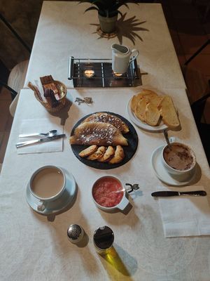 Desayuno con crepes de queso y mermelada de arándanos, empanadillas de pisto y tostadas at Molino del Corregidor in San Roman De Cameros