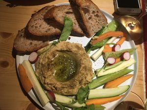 Hummus plate with veggie sticks and sourdough bread at Flores Da Pampa in Lisbon