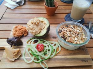 Vegan breakfast Laura: half an avocado, 2 types of hummus, dark chocolate spread, peanut butter, veggies, soy yogurt and granola and 4 slices of sourdough bread  at George in Mainz
