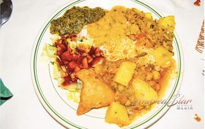 A platter with Indian vegan entrees and appetizer. at Royal India in Raleigh