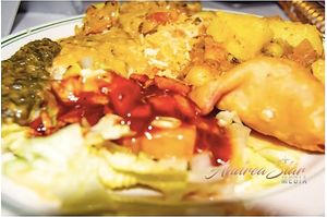 A platter with Indian vegan entrees and appetizer. at Royal India in Raleigh