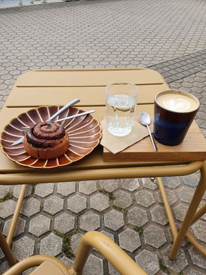 Coffee and cinnamon roll outside at OhBaba  in San Sebastian
