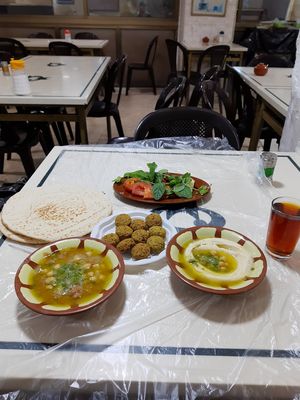 The perfect feast - falafel, fuul, hummus, pita, chai, and the garnish at Hashem in Amman