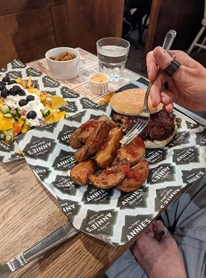 The BB-King Burger (vegan) with salted wedges. Vegan nachos/frickles in the background at Annie's Burger Shack in Nottingham
