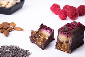 The Bakewell - Date, cashew and coconut base, almond marzipan centre with a raspberry chia seed topping at Goji Catering in Todmorden