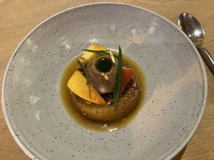 Peach cake with peach cream, calendula, and verbena at Oyster Oyster in Washington