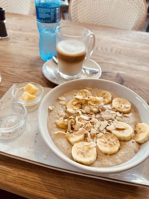 Nut butter and banana oats and a coffee latte, both made with plant-bass milk.  at Doppio Zero in Umhlanga