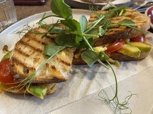 Avocado, cherry tomatoes, vegan cheese toastie with chilli jam. A good few options to choose between and plant based milks and smoothies. 😋 at Port Espresso in Brixham