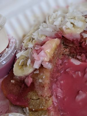 Breakfast pancakes with housemade pink coconut syrup, bananas and coconut at Bloom in Logan