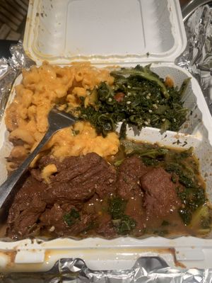 Oxtails with Mac n’ cheese and sautéed kale at Vegan Hood in New York City