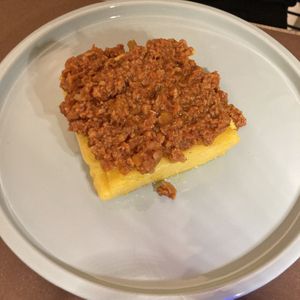 Polenta with soya ragú (local dish) at UNO Caffé Olistico in Bologna